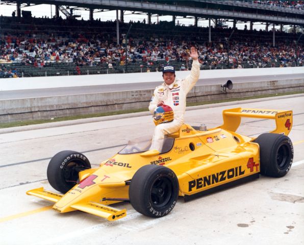 Johnny Rutherford celebrating his victory at the "Brickyard".